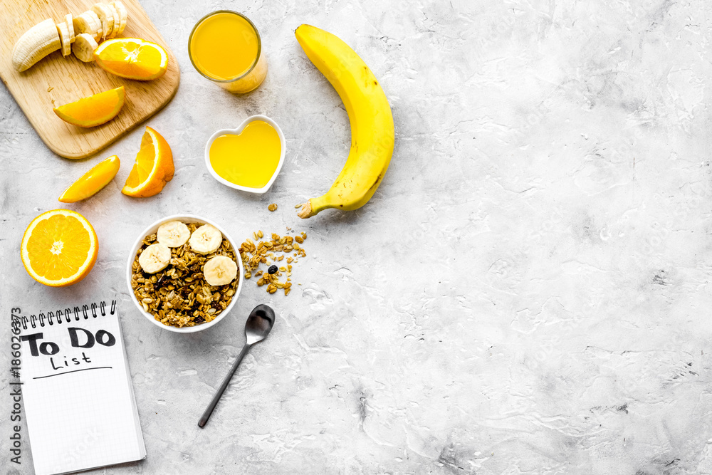 Start the day the right way. Healthy breakfast oatmeal with fruits and planning the day. Grey background top view copyspace Start the day the right way. Healthy breakfast oatmeal with fruits and planning the day. Grey background top view copyspace