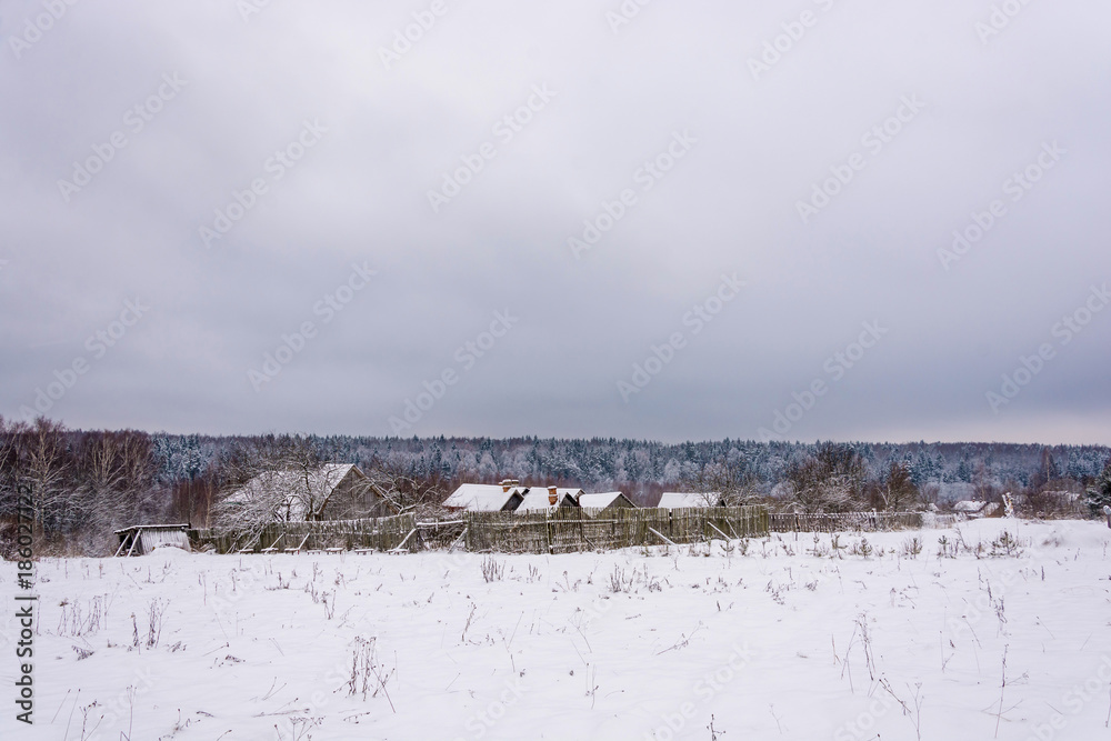 The village in a winter overcast day, Russia. The village in a winter overcast day, Russia.