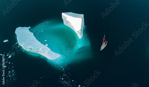 Iceberg and yacht. View from air. Drones view.
