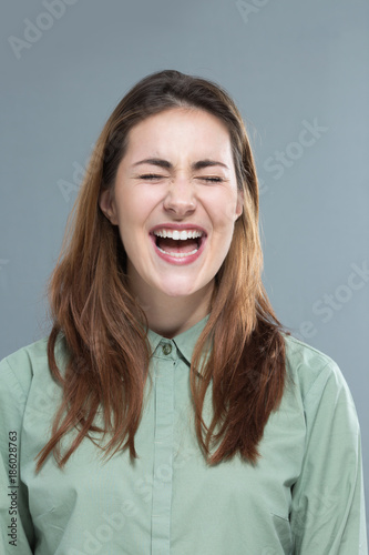 Portrait of beautiful young woman screaming with laughing