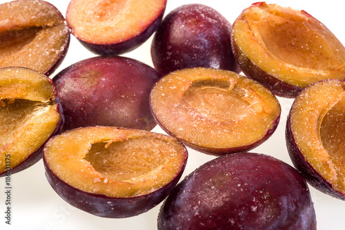 luscious frozen plum without pit isolated on white background, delicious first class organic fruit as a concept of summer vitamins © bondvit