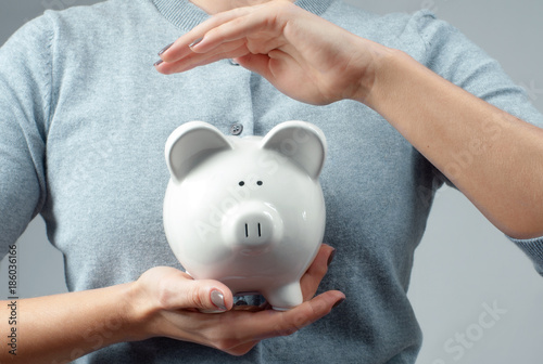 Savings concept. Woman holding piggy bank