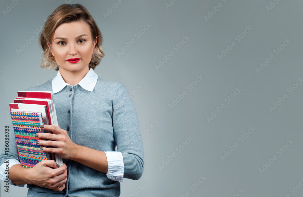 Naklejka premium Beautiful girl student holding books