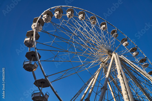 Construction and wagons of the Ferris wheel against the sky in Poznan.