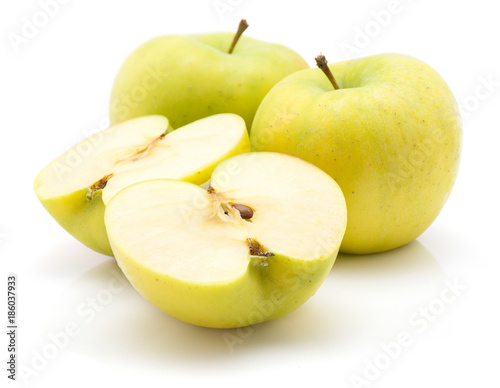 Fotografija Two apple (Smeralda variety) halves and two whole isolated on white background green yellow