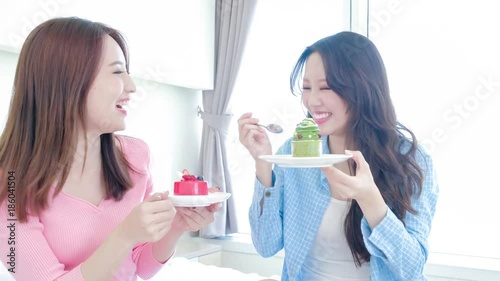 two beauty woman eat cake photo