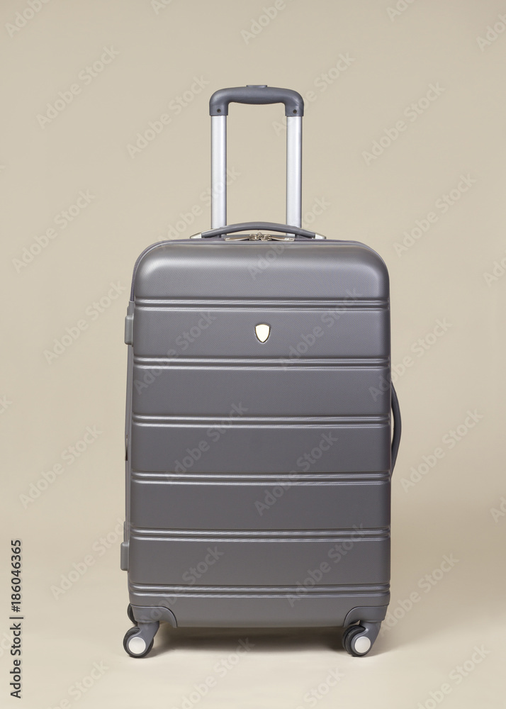 Gray modern suitcase isolated on pain background Gray modern suitcase isolated on pain background