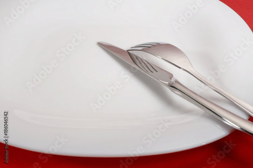 Fork and knife on white plate