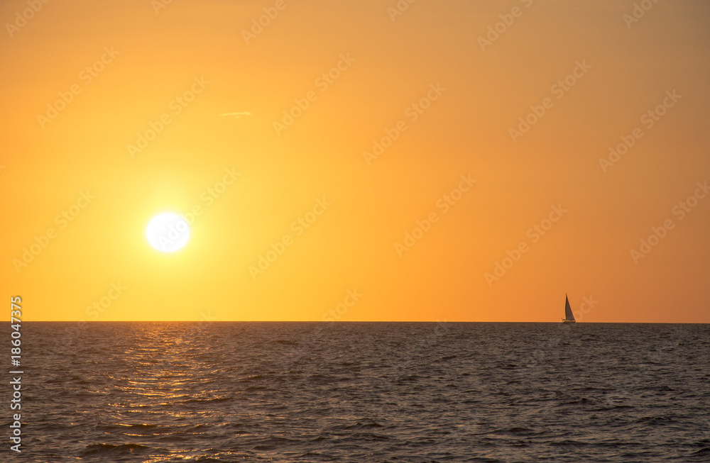 Florida Sunset horizon with a sailing boat 