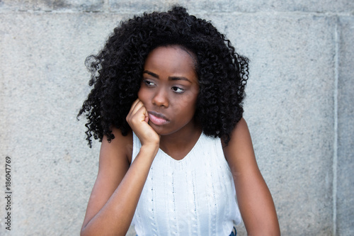Fényképezés Sad african american woman looking around