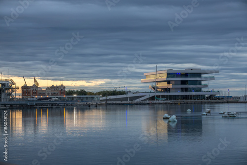Valencia harbor, port twilight, reflection in water wide angle, panoramic with modern and ancient buildings