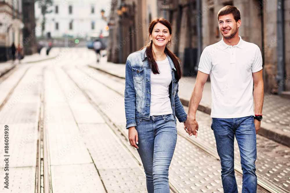 A good day to walk the streets of the city and a happy couple who enjoys this opportunity A good day to walk the streets of the city and a happy couple who enjoys this opportunity