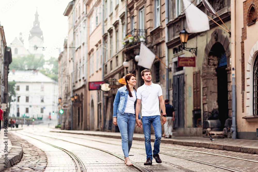 girl and boy holding hands walking around the streets of an ancient city girl and boy holding hands walking around the streets of an ancient city