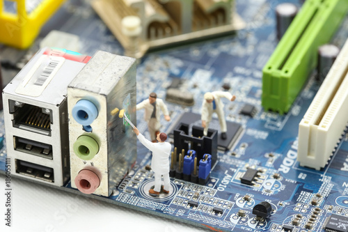Miniature people : engineer and worker working on computer mainboard bitcoin concept.