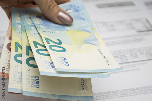 Money bills, euros close-up on the tableMoney bills, a person pays the bill, the euro in hand photo