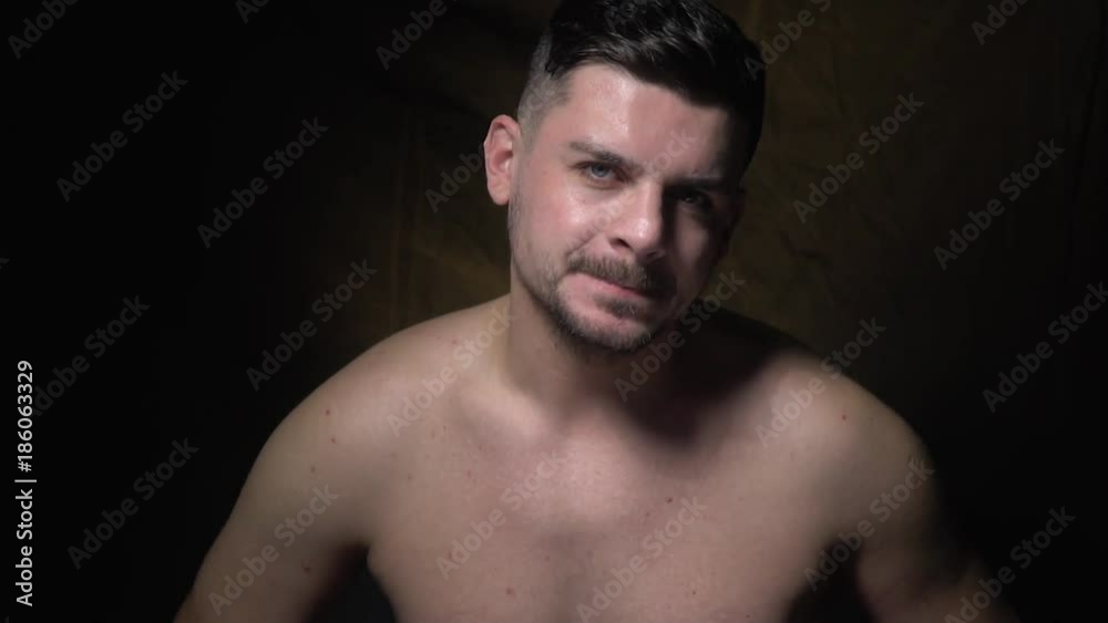 A man with a cunning face calls to himself and winks A man with a cunning face calls to himself and winks