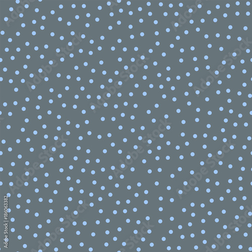 Blue polka dots seamless pattern on grey background. Gorgeous classic blue polka dots textile pattern in restrained colours. Seamless scattered confetti fall chaotic decor. Vector illustration.
