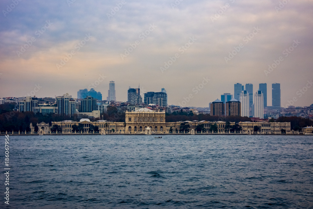 Fototapeta premium Dolmabahçe Palace and skyscrapers in the background