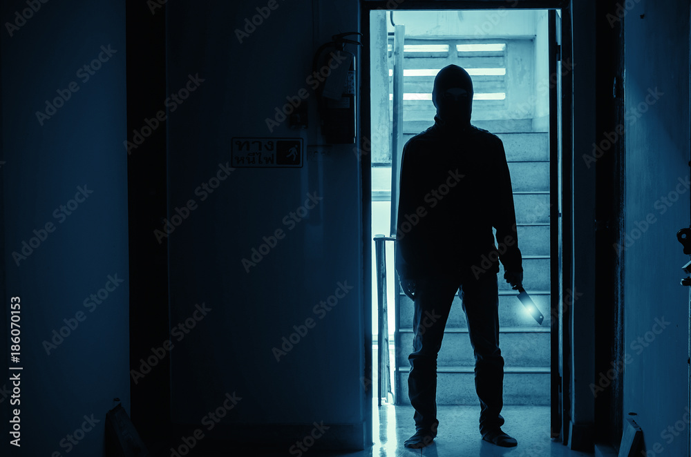 Epic concept with man in silhouette holding knife inside a condo
