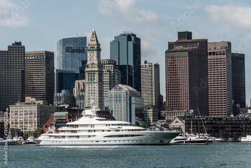 Yacht and sailing boats on Charles River in front of Boston Skyline in Massachusetts USA on a sunny summer day