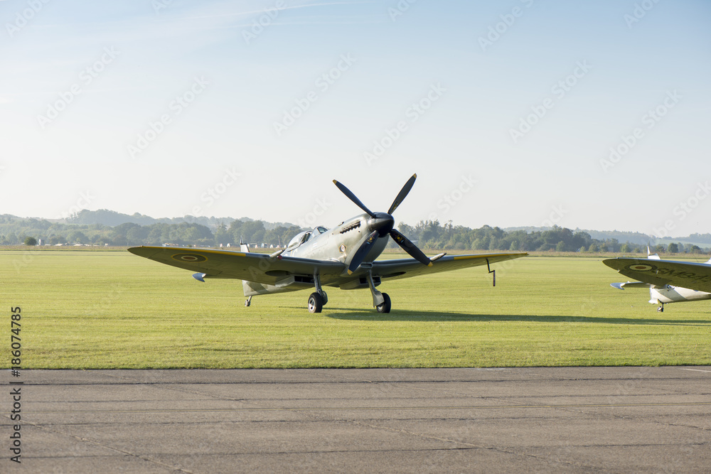 Angled Front View of Classic Spitfire Aircraft by a Runway Angled Front View of Classic Spitfire Aircraft by a Runway