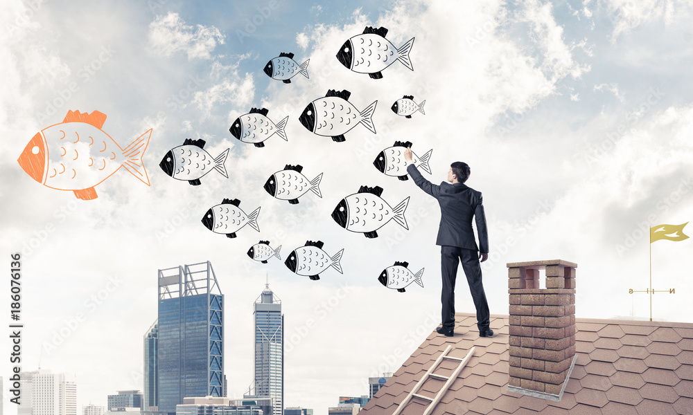 Businessman standing with back on house brick roof and drawing. Businessman standing with back on house brick roof and drawing.