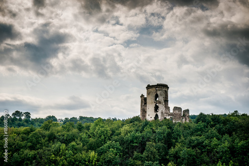 two towers of the old castle. Ruins of the palace side. Chervonogradsky Castle, Ukraine. Clouds in the sky. 