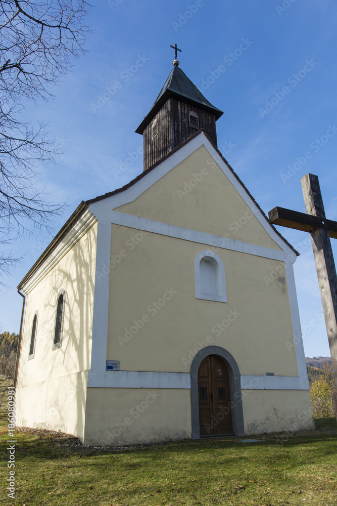 The front of the church with a bell tower.