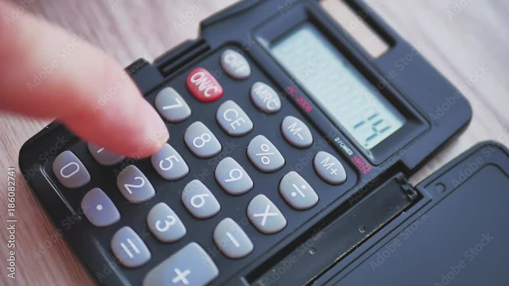 Counting on calculator. Fingers presses the button calculator. Closeup. Counting on calculator. Fingers presses the button calculator. Closeup.