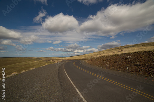 winding road with cloudy blue sky