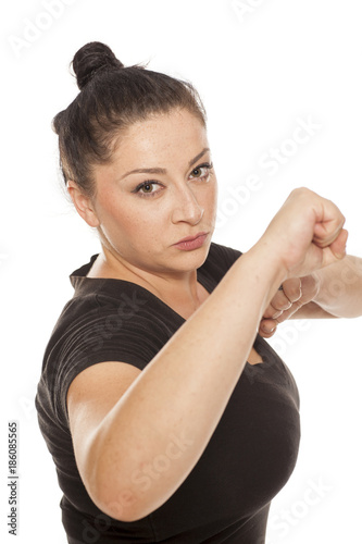 young woman in defensive position on white background
