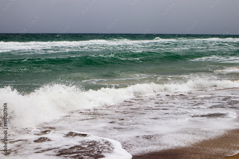 View of the stormy sea from the shore