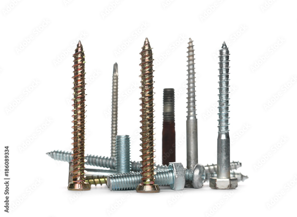 Pile metal nails, screws, bolts and nuts isolated on white background Pile metal nails, screws, bolts and nuts isolated on white background