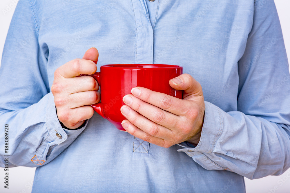 Woman is holding red cup