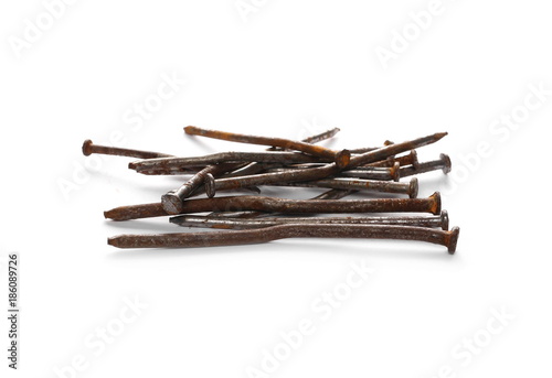 Pile of old, rusty metal nails isolated on white background