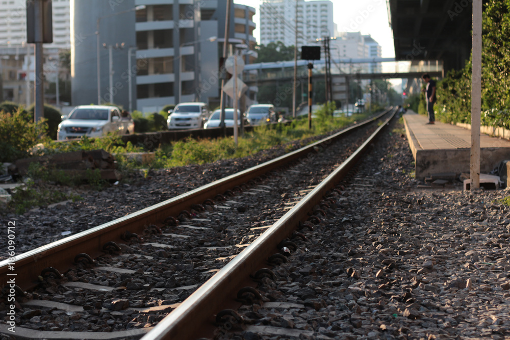 Railroad tracks in Bangkok Thailand with light sunset in evening Railroad tracks in Bangkok Thailand with light sunset in evening