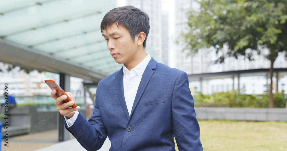 Businessman use of mobile phone at outdoor Businessman use of mobile phone at outdoor