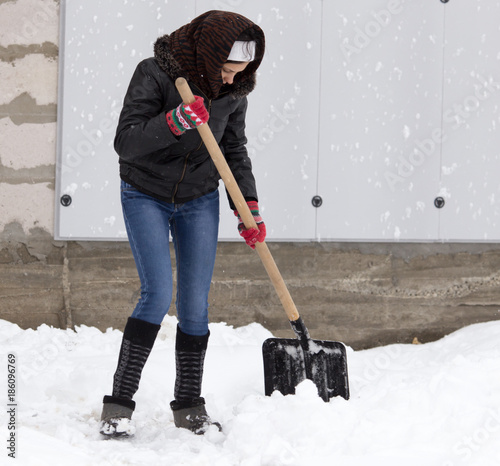 Girl with a shovel cleans the snow © schankz
