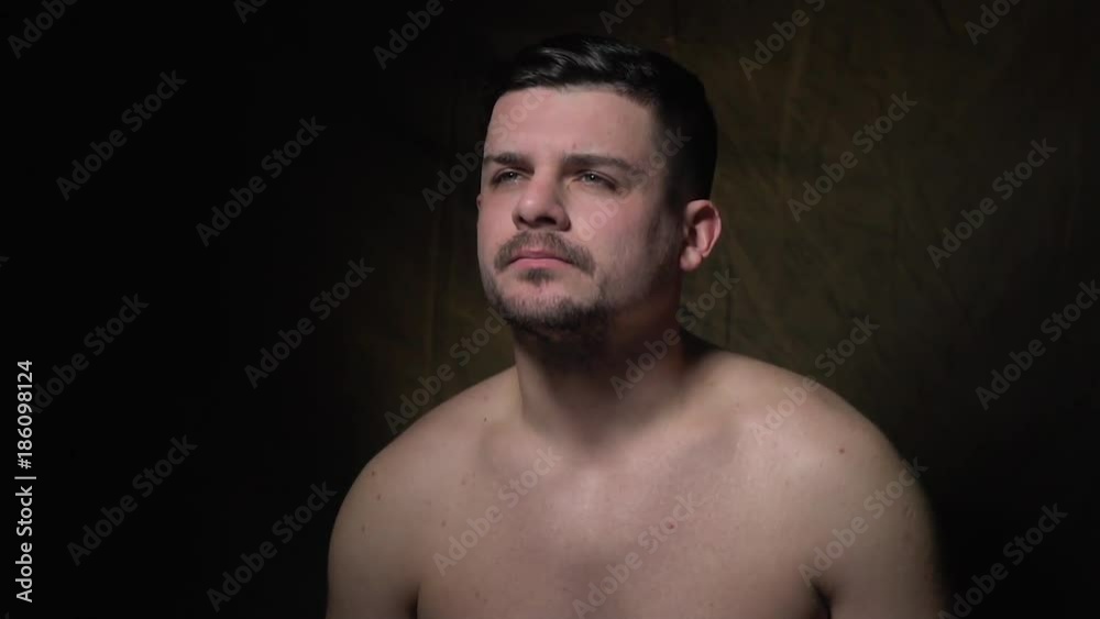 The dark-haired man with a beard thinks about something The dark-haired man with a beard thinks about something