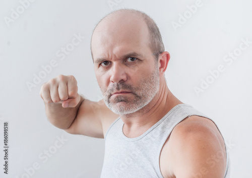 Man with a gray beard, punches his fist, fight