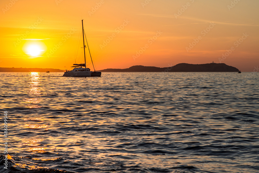 Sail boat against sunset