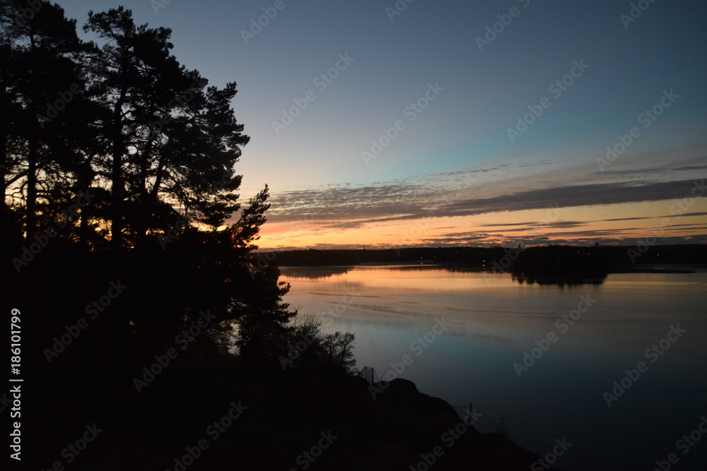 View over the lake from a cliff with trees View over the lake from a cliff with trees