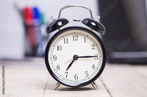 Black Alarm clock on table Business background,concept time to work