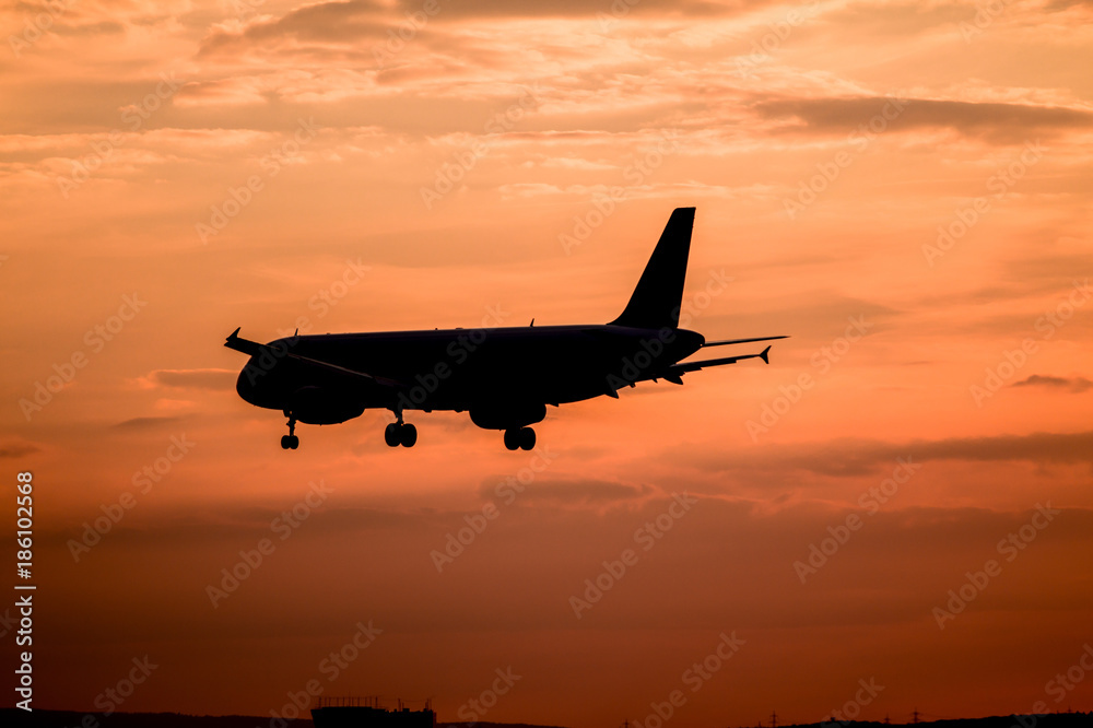 Airplane landing at sunset Airplane landing at sunset