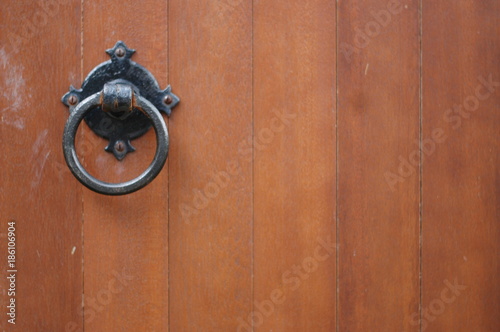 Old fashioned door handle on a wooden church door.