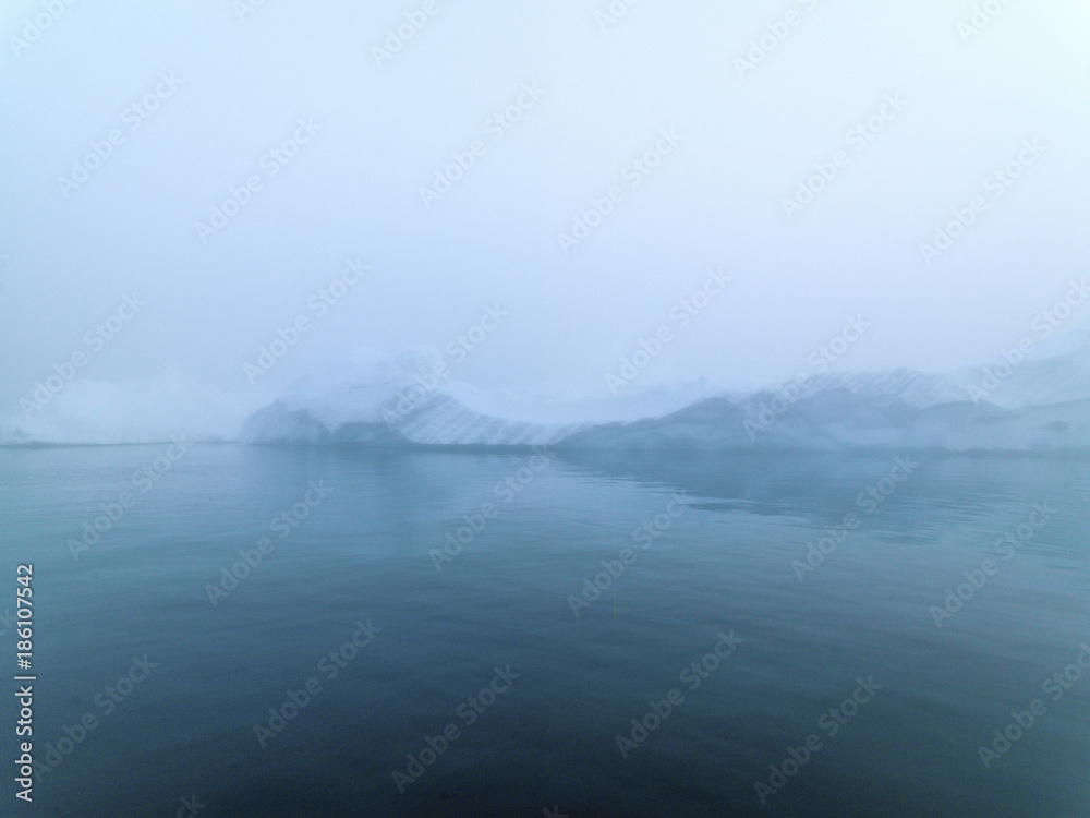 Icebergs in foggy day on Arctic Ocean in Greenland