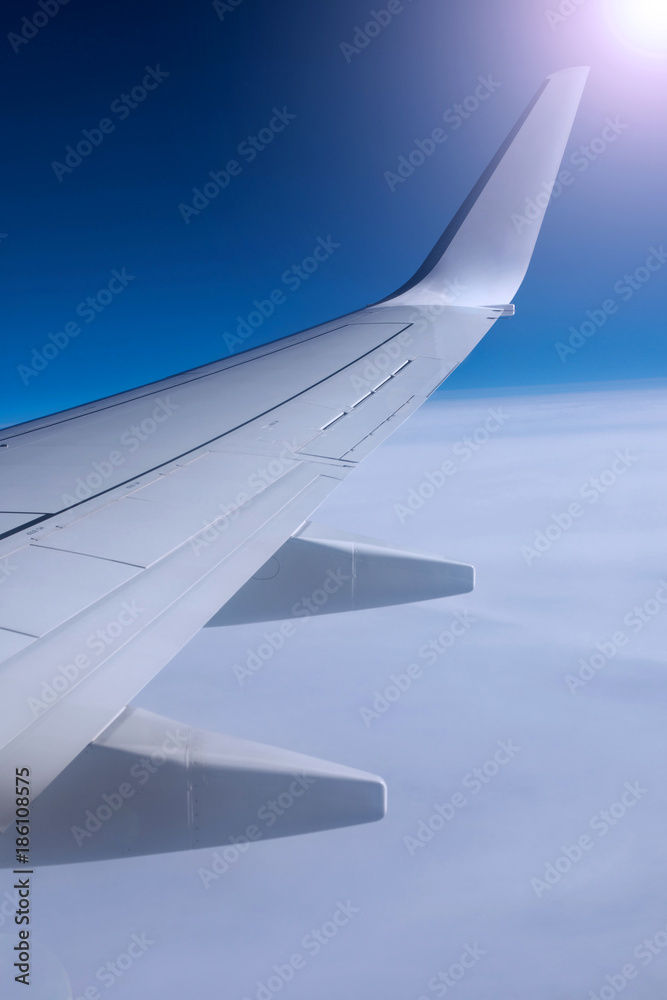 Fototapeta premium Beautiful view from window of airplane in sunrise sky