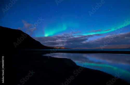 Northern lights background dancing over lake in Abisko national park in Sweden