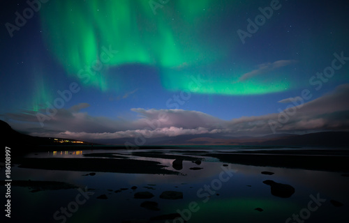 Northern lights background dancing over lake in Abisko national park in Sweden © Conny Sjostrom