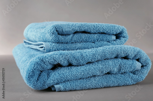 Soft terry towels on grey background